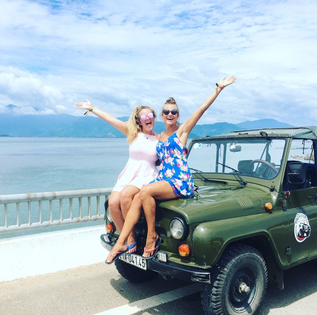 Girls sat on a jeep on the high van pass