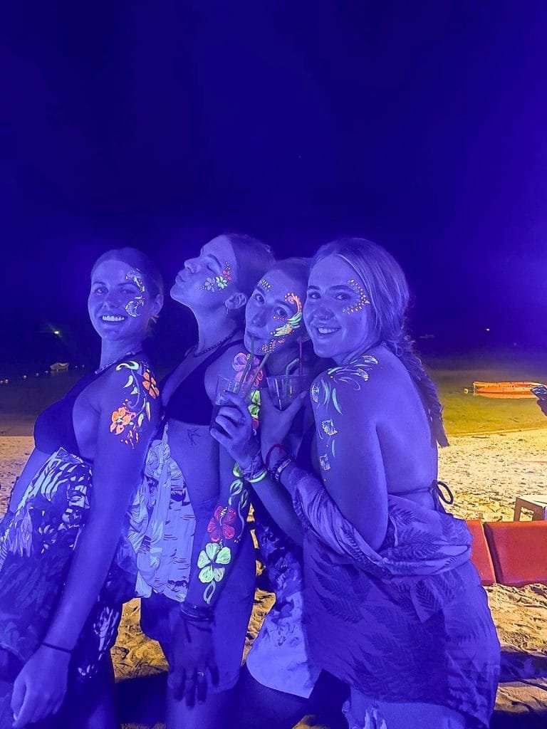 Girls with Neon paint at a beach party
