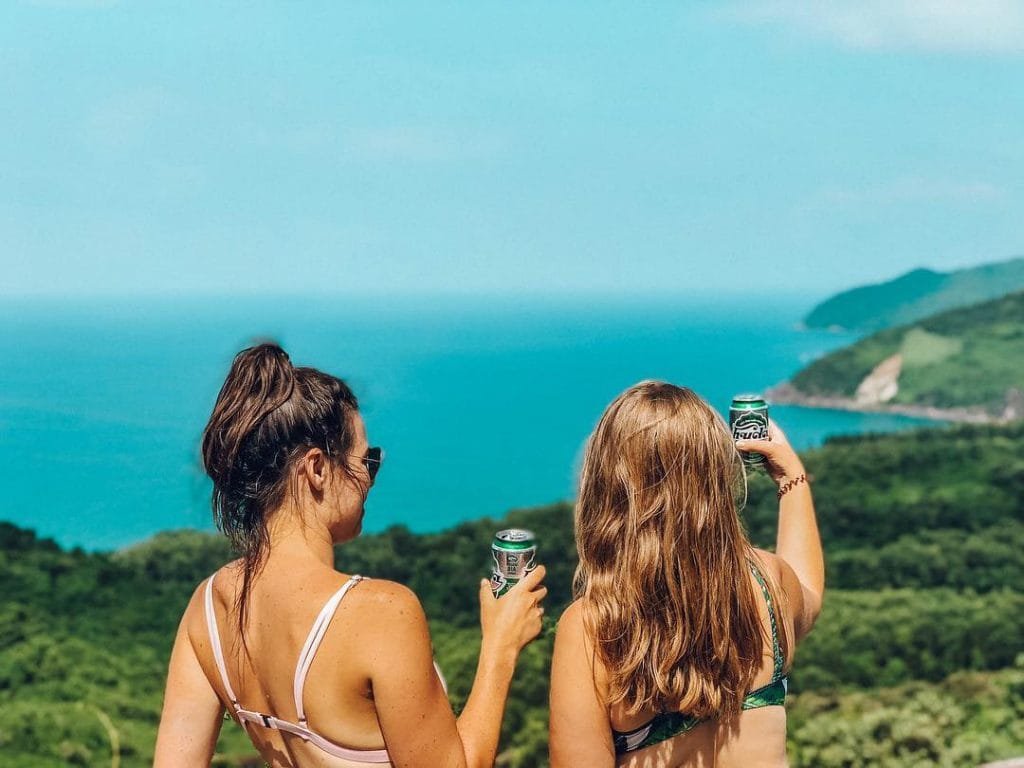 Girls drinking beers while looking at the view from Hai Van Pass
