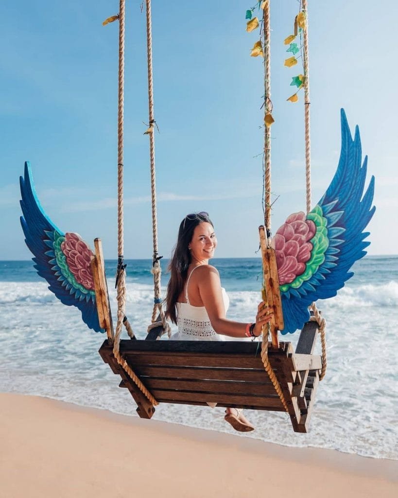 Girl on a swing at Angel Beach Unawatuna, Sri Lanka
