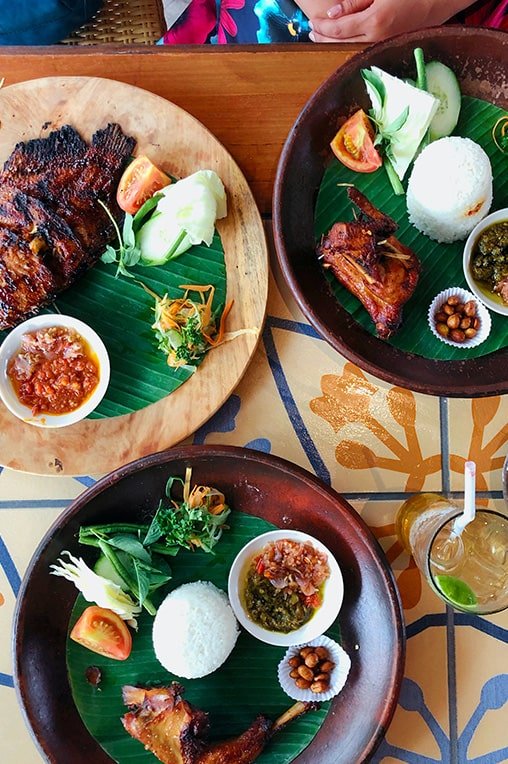 A picture of 3 plates of food served in Uluwatu. The food here is great and another of the main reasons to visit Uluwatu 