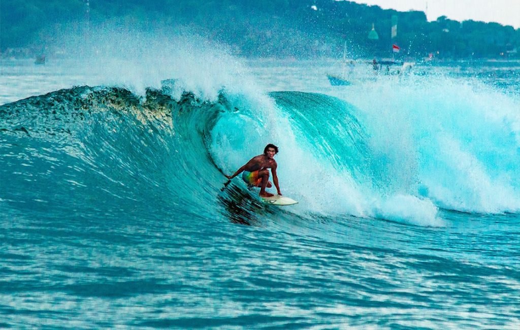 A picture of a man surfing in Uluwatu 