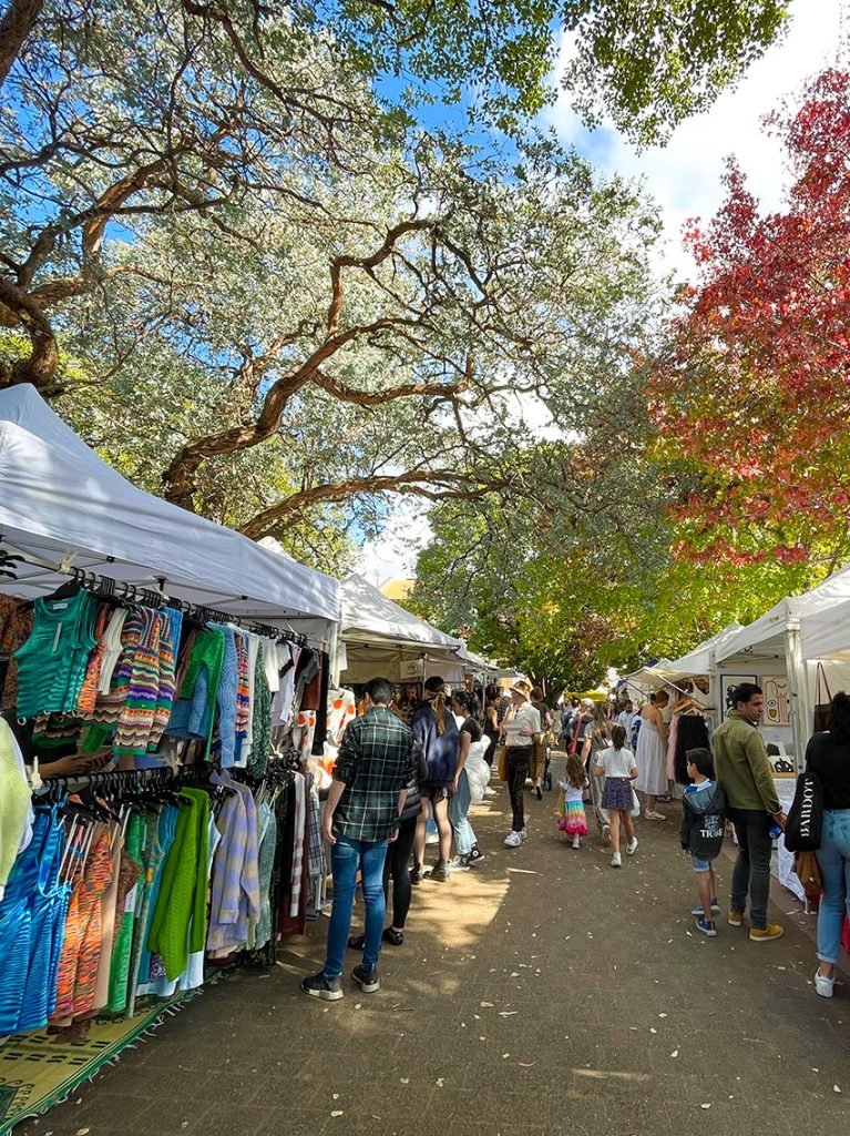 A picture of some stalls at the Glebe Markets, walking through the markets is one of the best free things to do in Sydney.