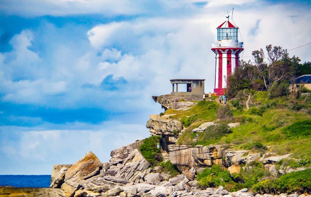 A picture of a red and white lighthouse in the National Park.
