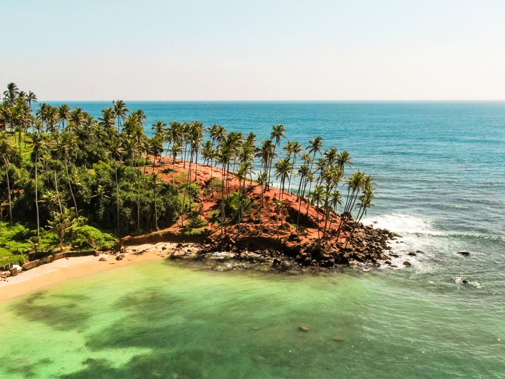 Aerial shot of Coconut Tree Hill in Sri Lanka, featuring the iconic palm trees overlooking the Indian Ocean with panoramic coastal views.