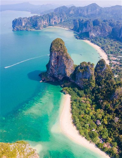 Relax and sip coconuts on the white sands of Railay Beach