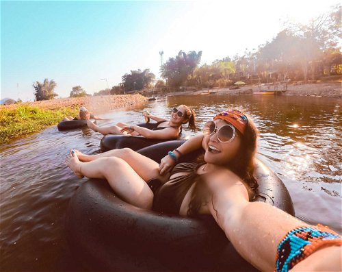 Grab a beer and float down the river in a tube during sunset